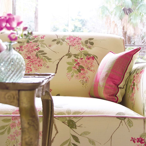 Sofa with flower design on it and pink pillow