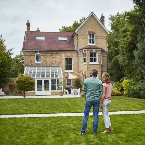 Couple in garden of fancy home