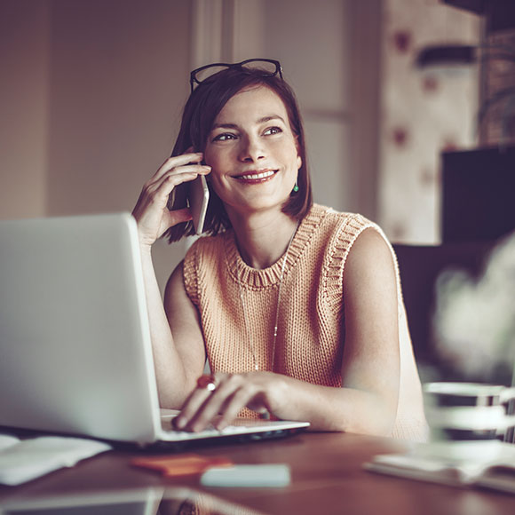 Woman on phone and on laptop