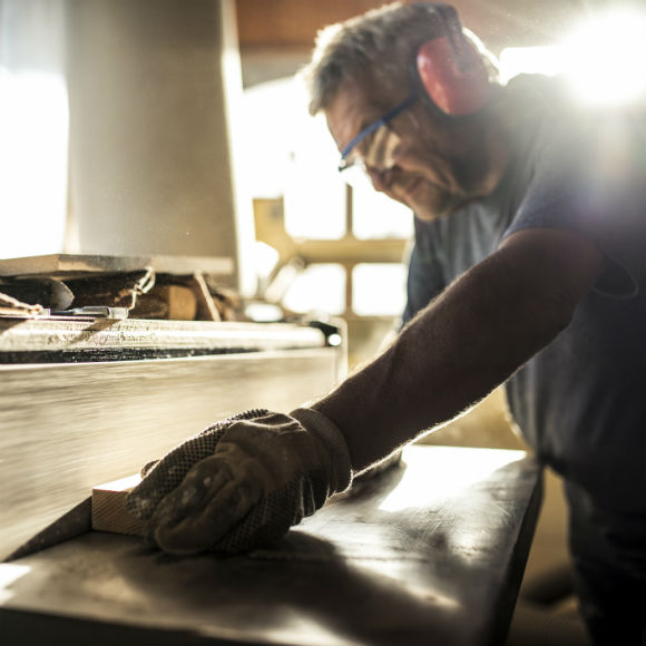 Carpenter working against belt sander