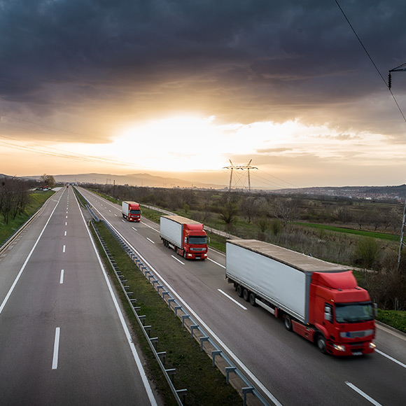 Three lorrys driving on near empty motorway