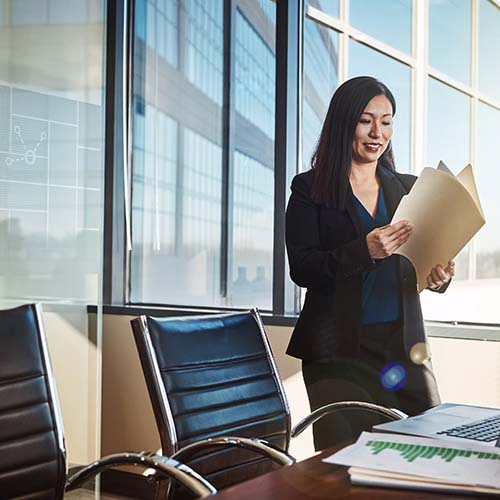 Woman reading document in office