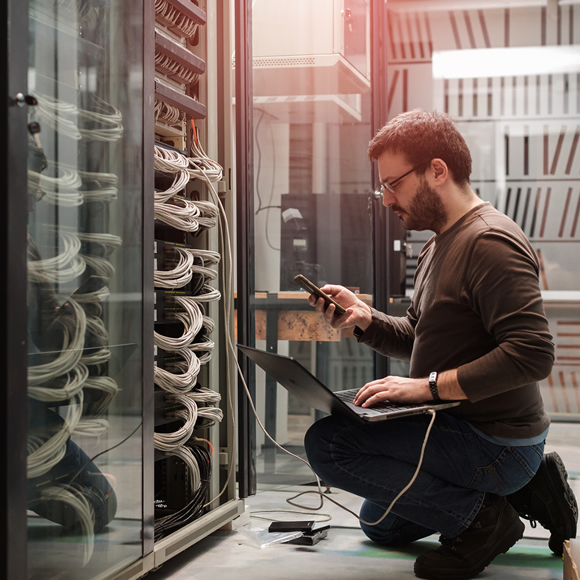 IT admin working on server rack